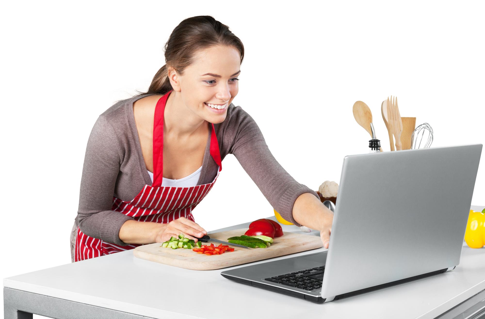 Student chopping vegetables during an online class